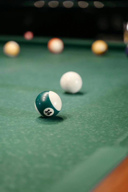 billiard balls and the cue rest on the pool table