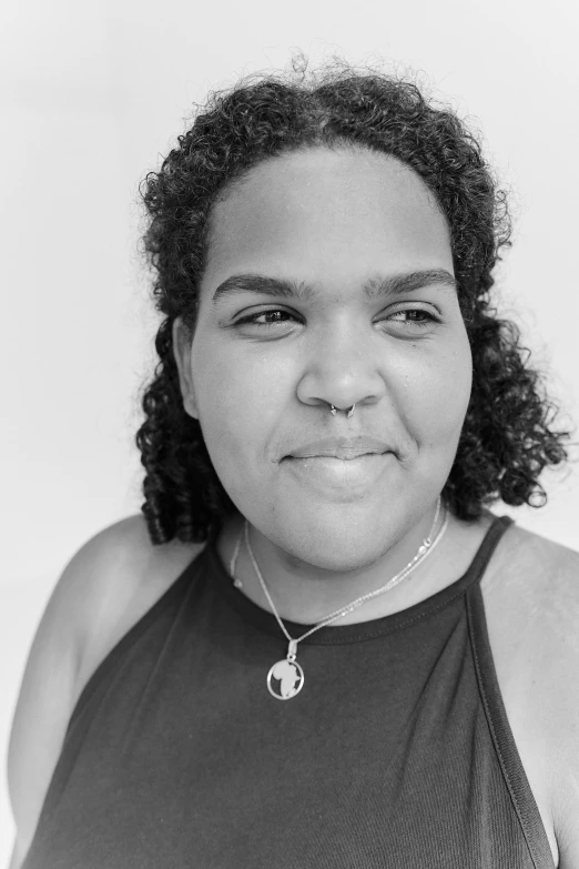 a black and white pograph of a woman with curly hair