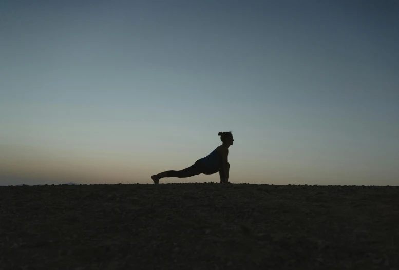 the person is doing yoga in the field