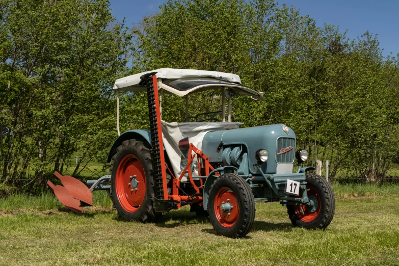 a large tractor sitting on top of a lush green field