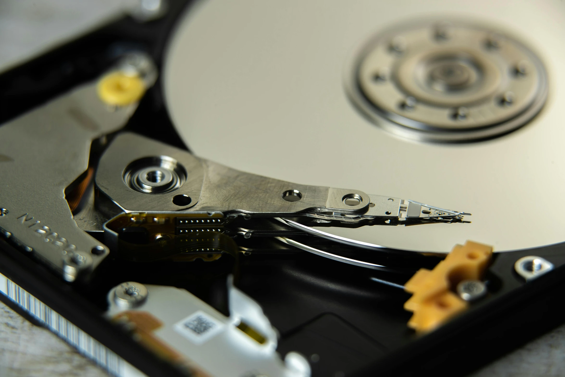 a hard disk drives out with several tools around it