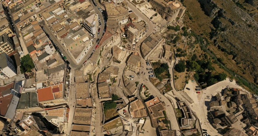 a small, rocky area with a few buildings and a street