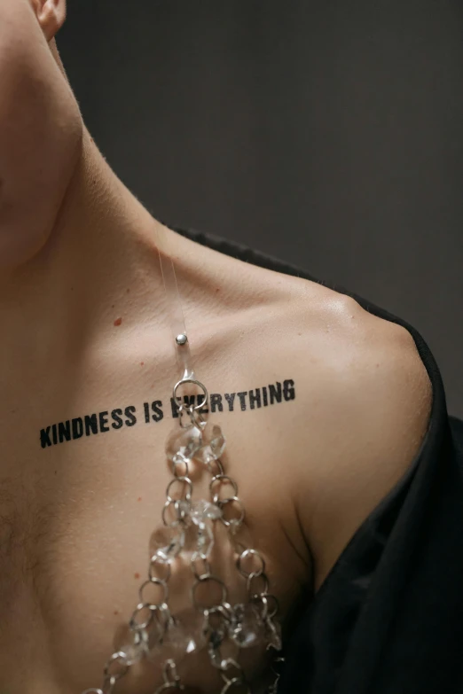 a woman with a body tattoo reading, sadness is everything