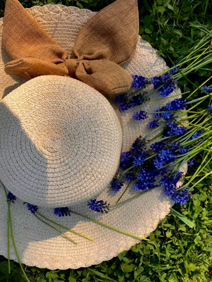 a hat is sitting on top of the flowers