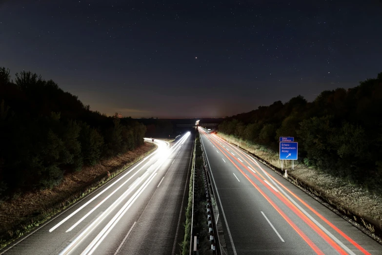 a highway with long - exposure and car lights at night