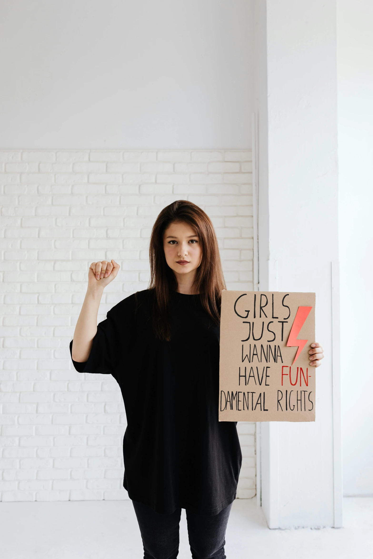 a woman holding up a sign and posing for the camera