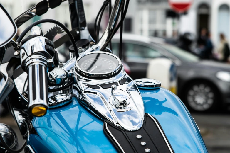 a blue motorcycle parked in front of another car