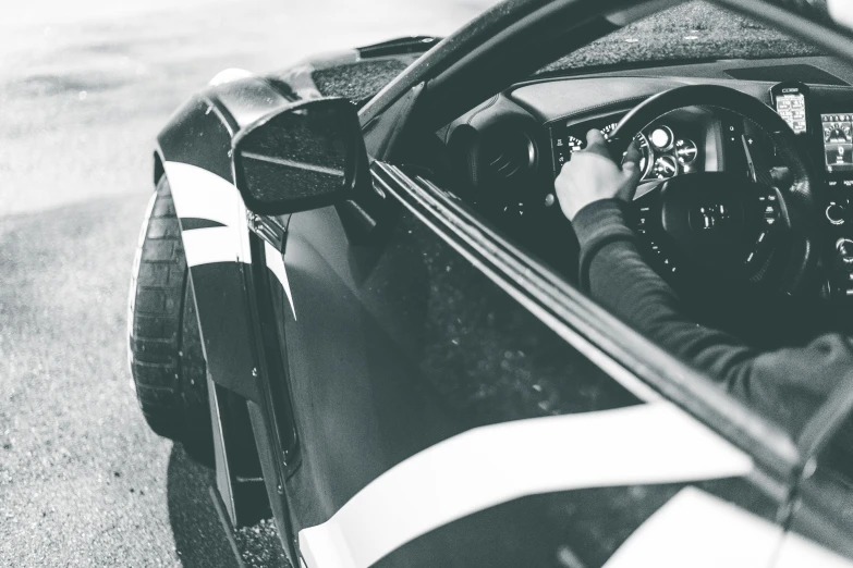 a man in a vehicle driving along a street