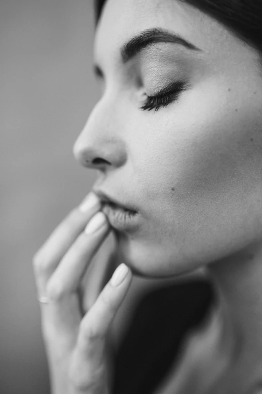 black and white po of a woman with eyes closed