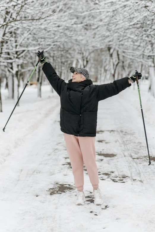 a woman on skis standing on snow covered ground