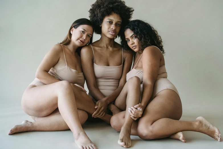 three women in  ones pose for a pograph