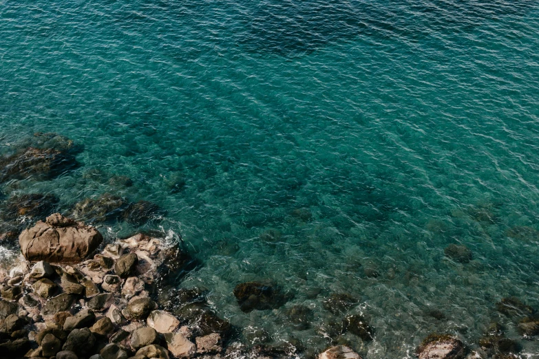 view from above looking down on a beach with blue water