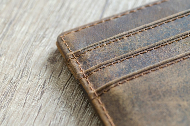 a wallet sitting on a wood table top