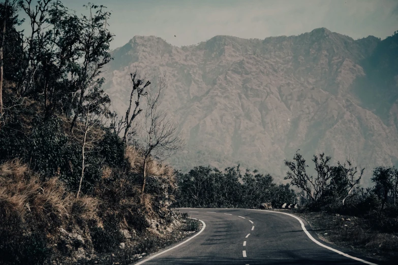 the view down the middle of a long and winding road