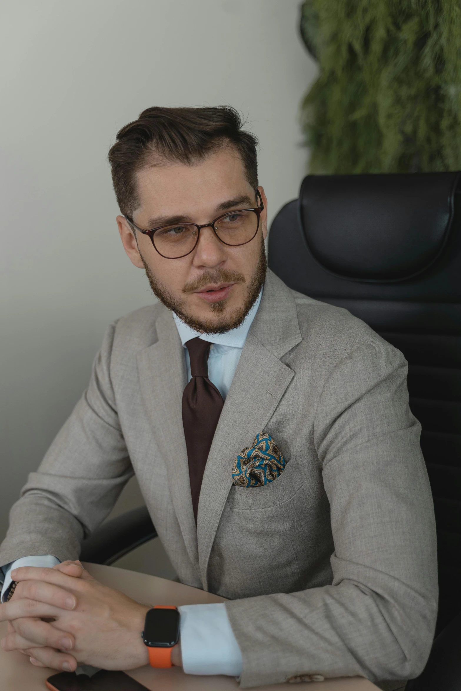 a man in a suit sitting at a table