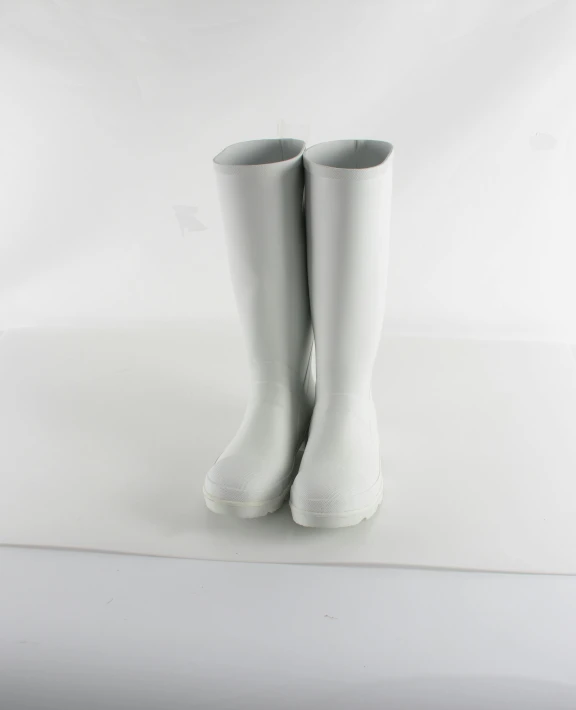 a pair of well - worn white high heeled boots