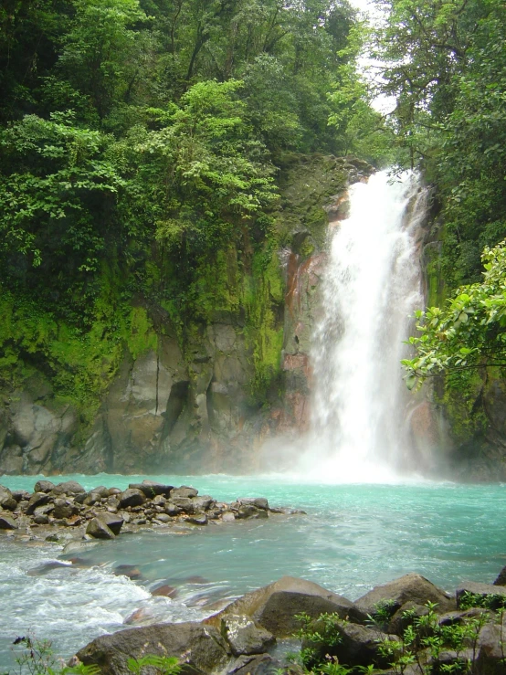 some people sitting near the side of a waterfall