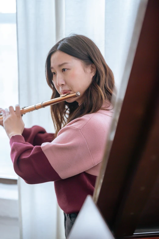 a young woman with an instrument is smiling