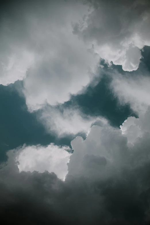 a plane is flying thru the cloudy sky