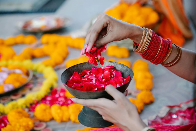 hands are being painted with pink and orange dye