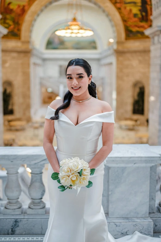 a bride poses for a pograph in the hall