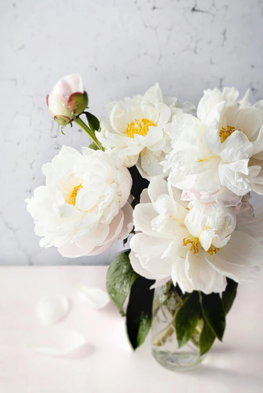 an arrangement of flowers in a vase on the table