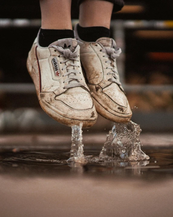 a person stepping on a glass base with water