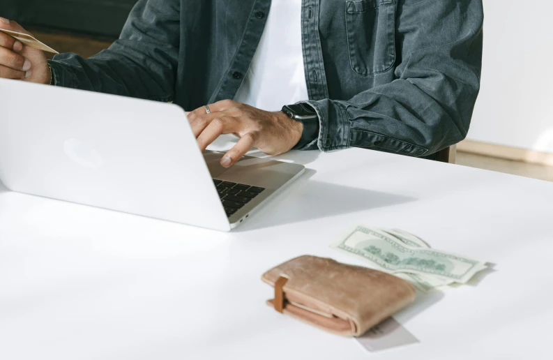 a man that is typing on a laptop