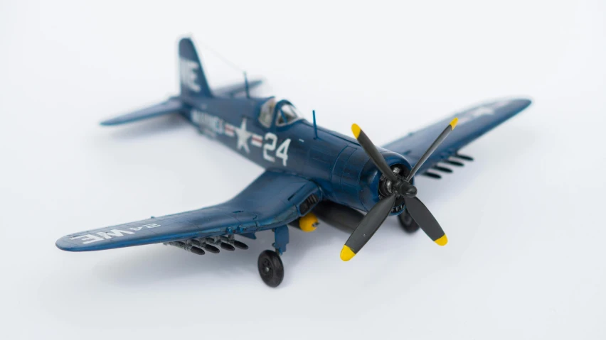 a close up of a model blue airplane with propellers