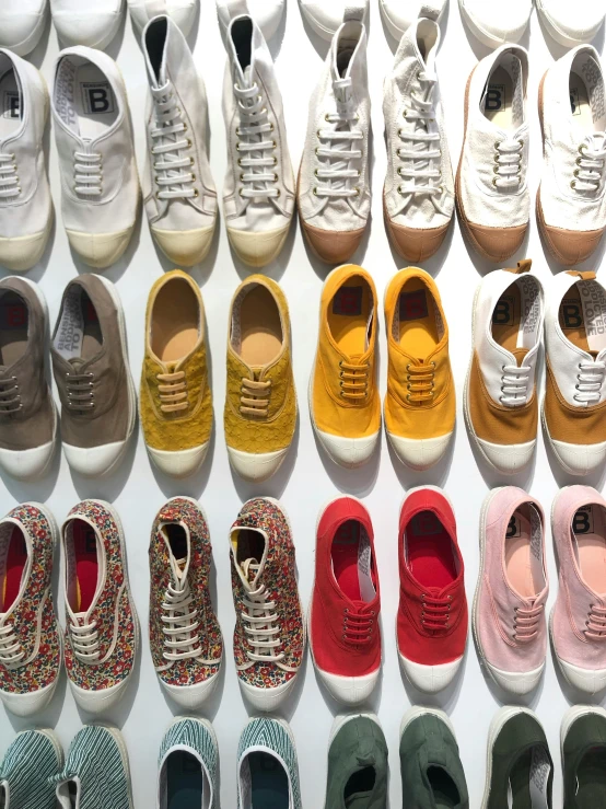 a collection of shoes sitting in rows, all covered with patterns