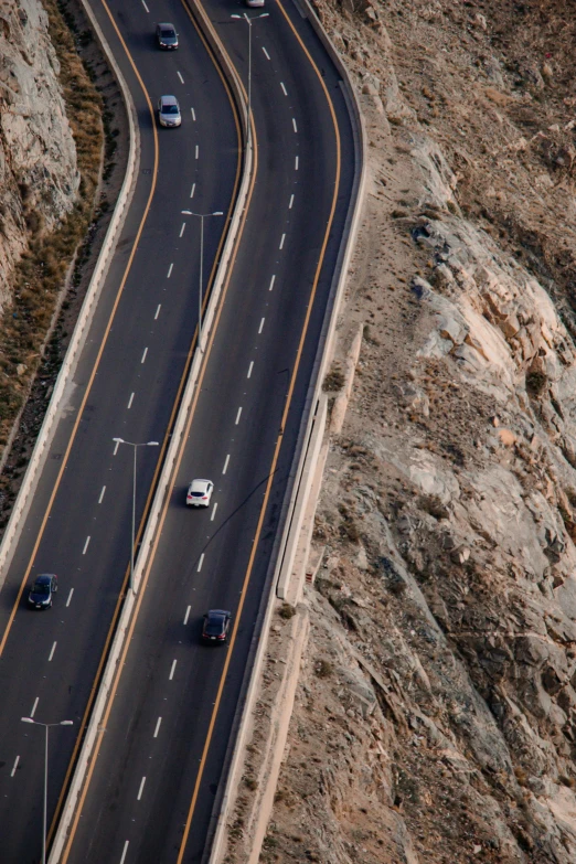 three lanes of freeway between two rocky mountains