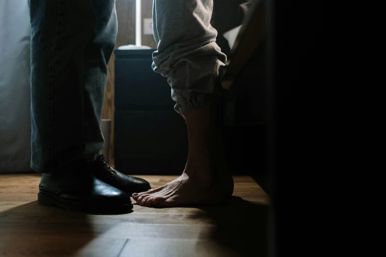 a couple stands with their feet in a doorway