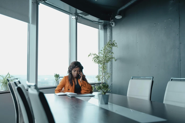 a woman that is sitting in a chair and looking at a cell phone