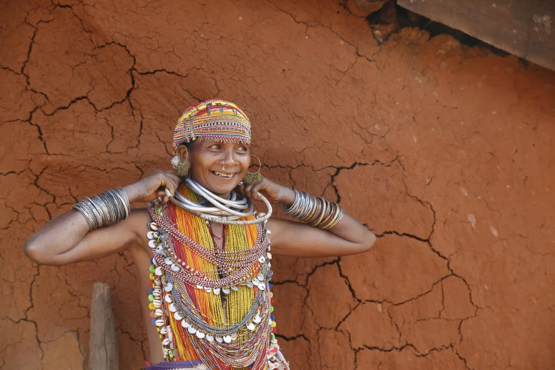 a woman wearing a brightly colored beaded piece of art