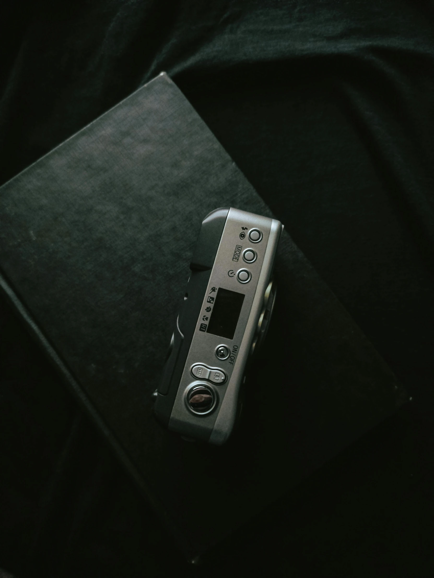 an old video camera sitting on top of a folder