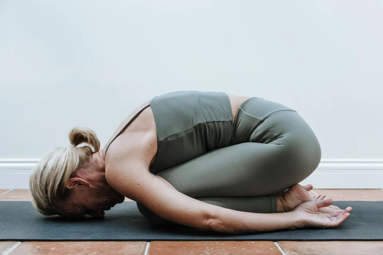 a woman doing yoga poses on a mat