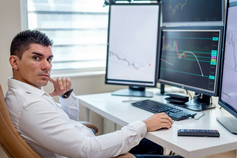 a man is sitting in a chair by a computer