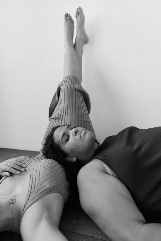 a black and white po of a woman laying on the floor