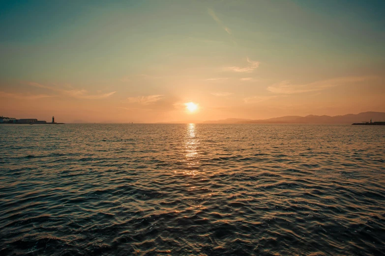 a po of a large body of water during sunset