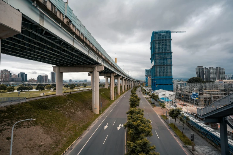 an aerial view of city roads with tall buildings in the background