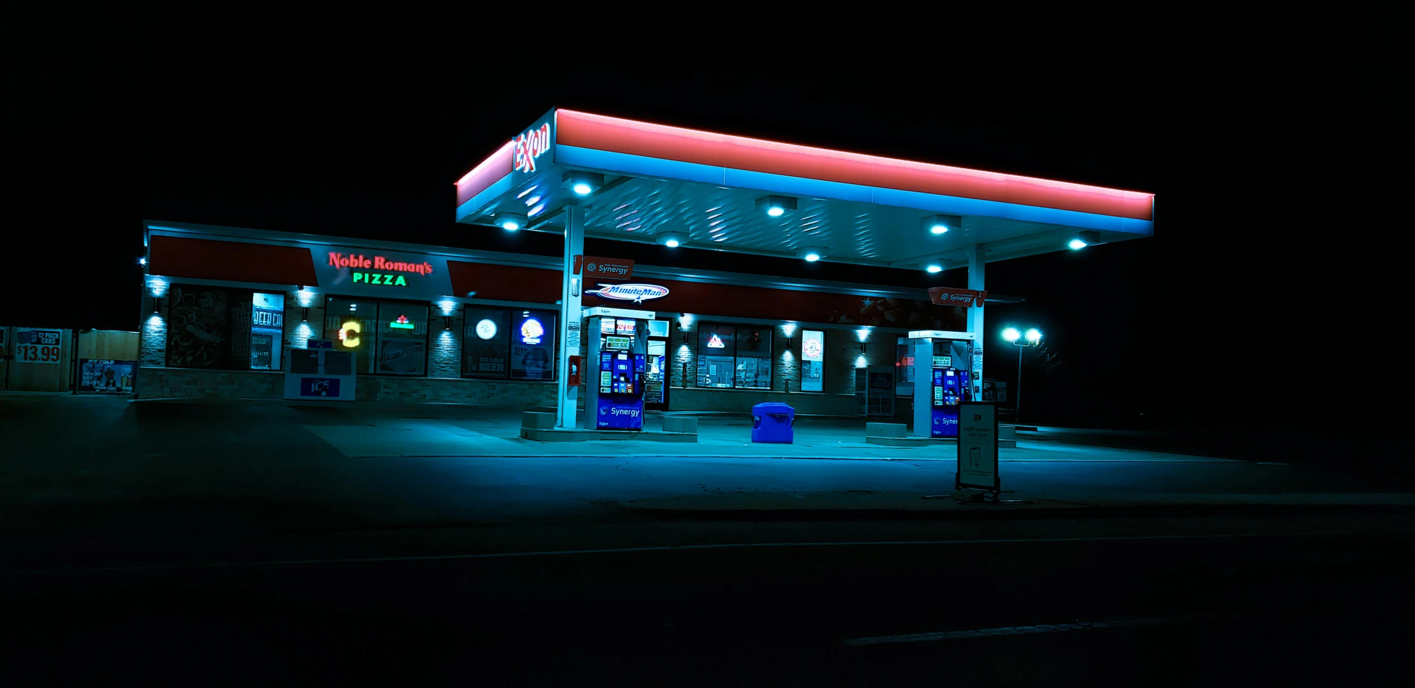 gas station at night with gas pumps and lights