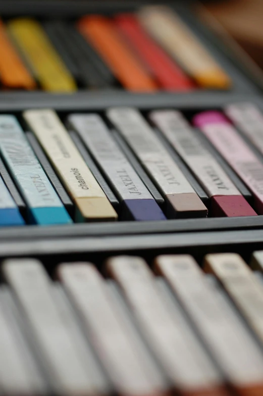 a close up of several rows of color pencils