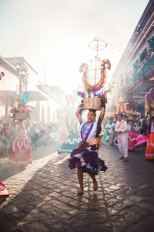 a woman carrying baskets in the middle of the street