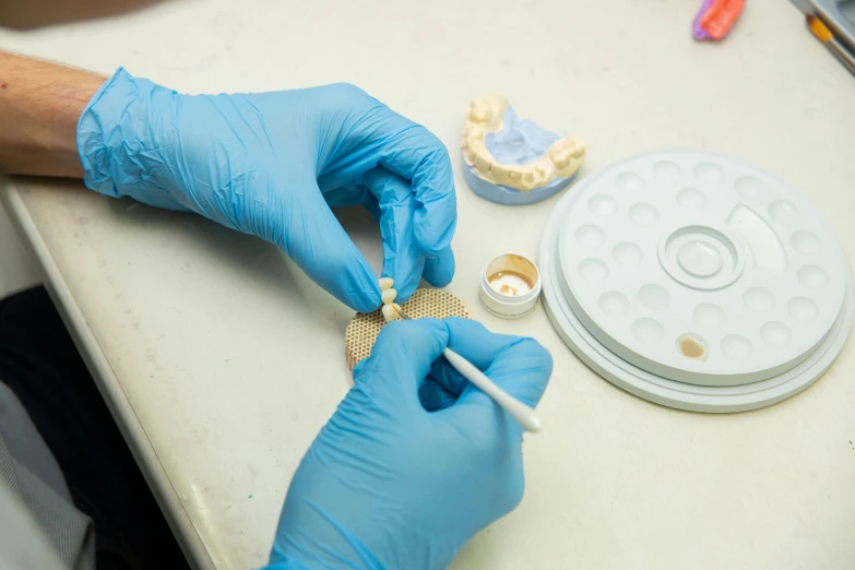 an eye surgeon examines a condom and glue