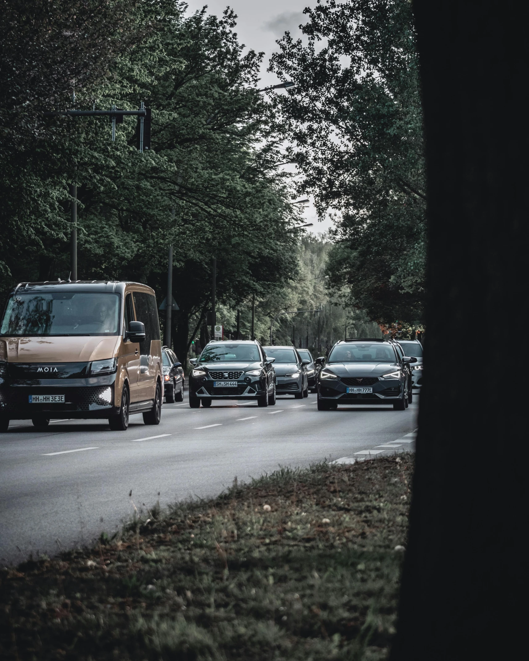 cars are lined up on the side of a road