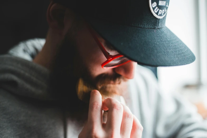 a man in a baseball hat holding a piece of food