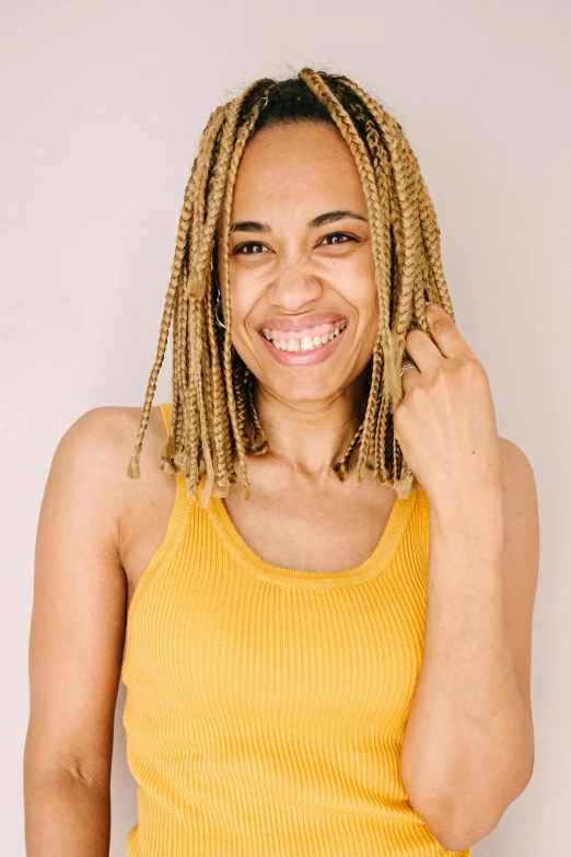 a woman with dread locks and a yellow top