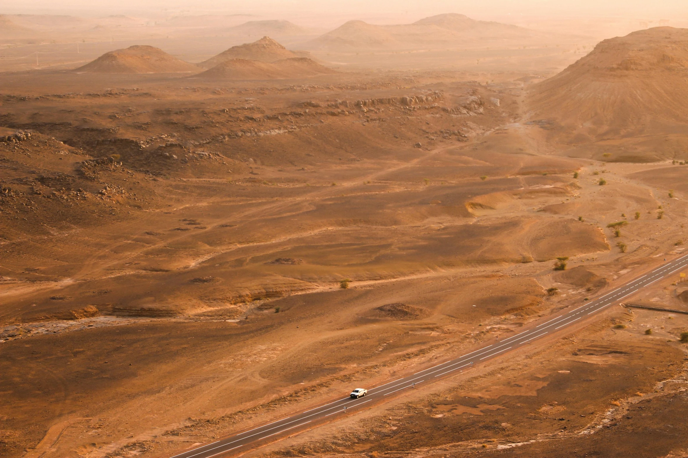 the vehicle drives through the desert on its track