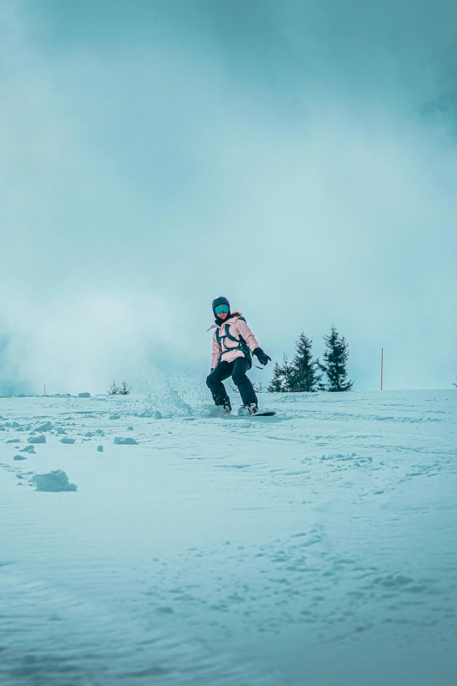 a skier in pink is going down the slope