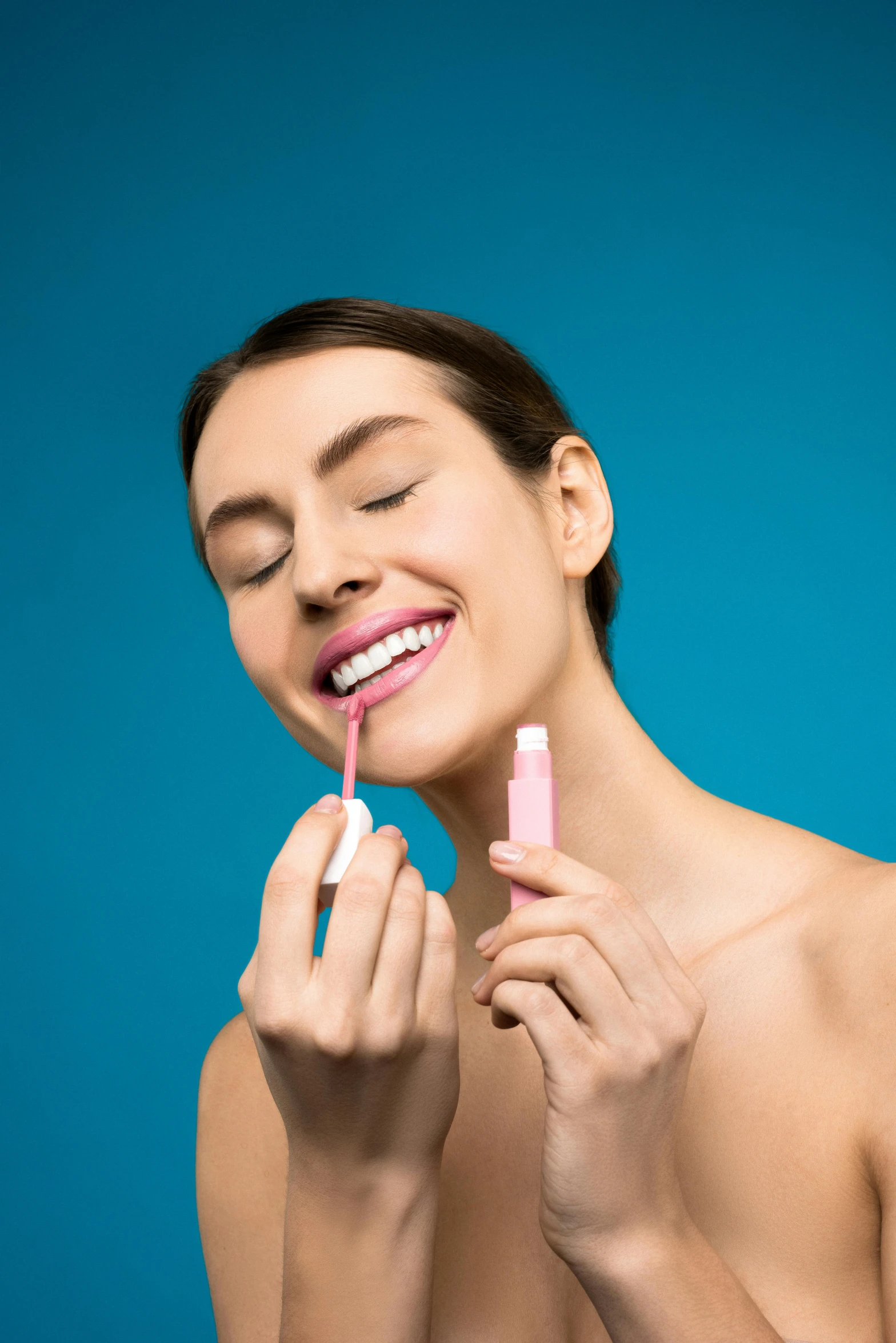 a young woman poses for a selfie with her lip open and her eyes closed